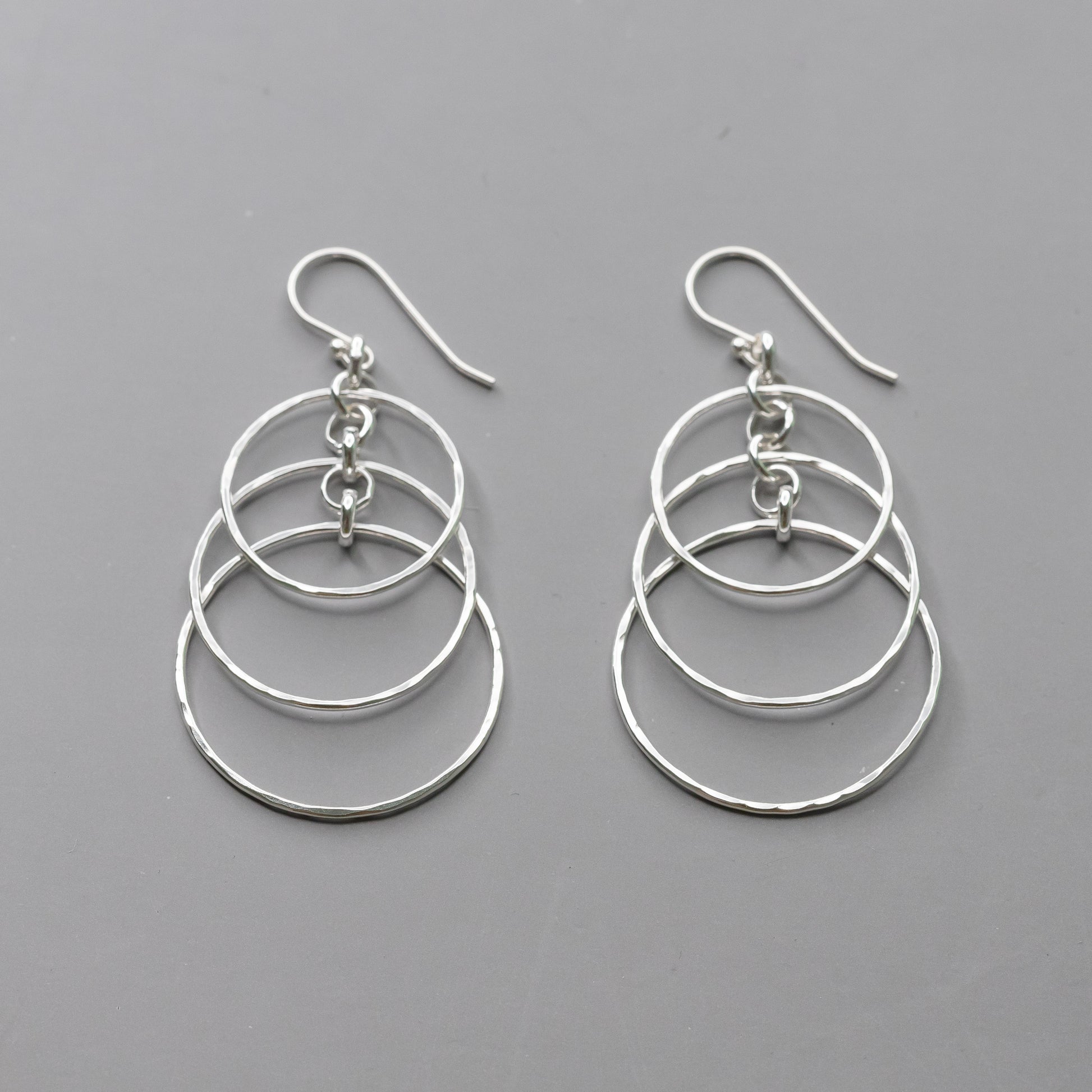 Handmade Sterling Silver Dangle Earrings with layered circles and hand hammered texture.  Polished to a high shine these artisan crafted earrings are nickel free and made with argentium silver.