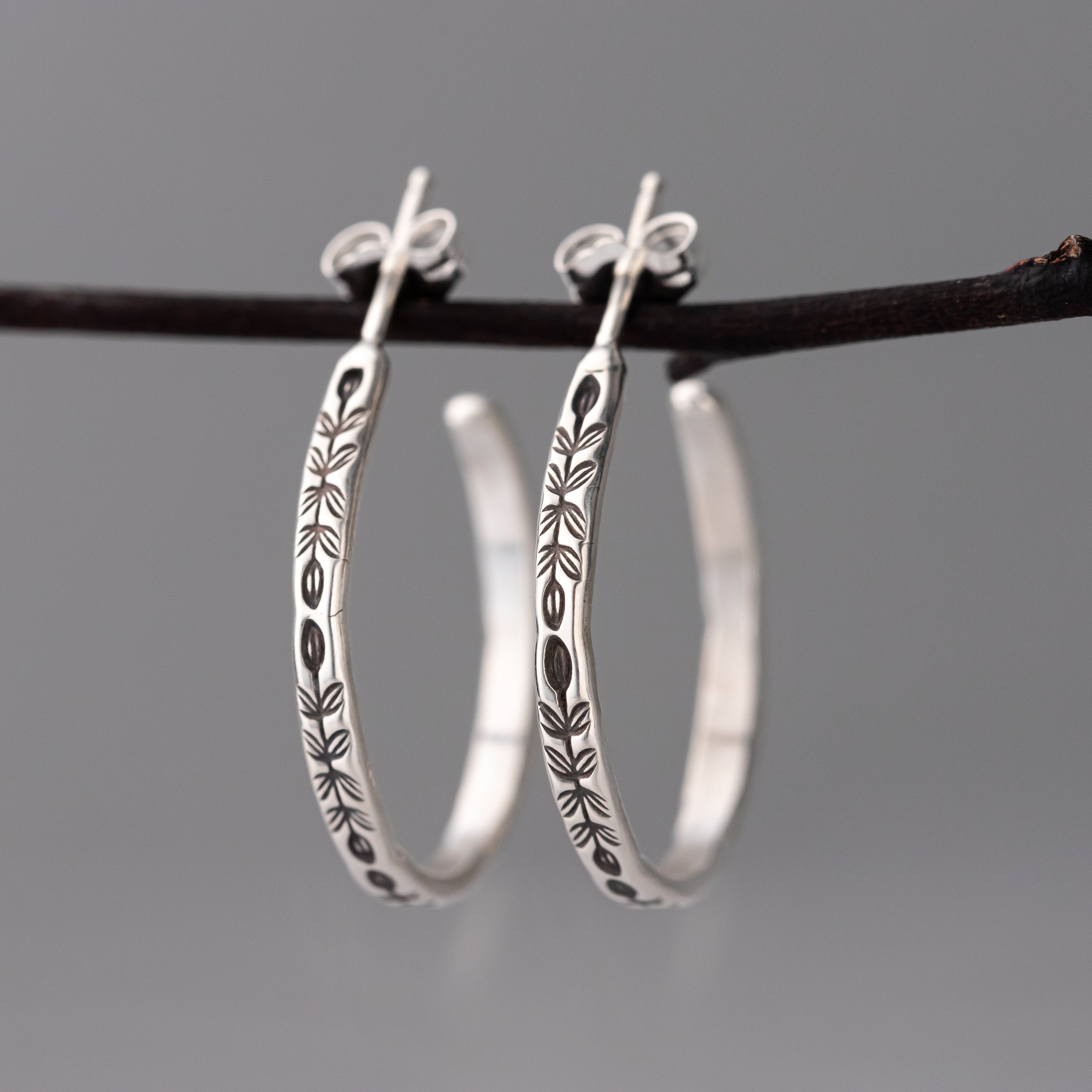 botanical inspired handmade sterling silver jewelry, handcrafted sterling silver hoop earrings with hand stamped artisan vine detail, oxidized silver jewelry for her