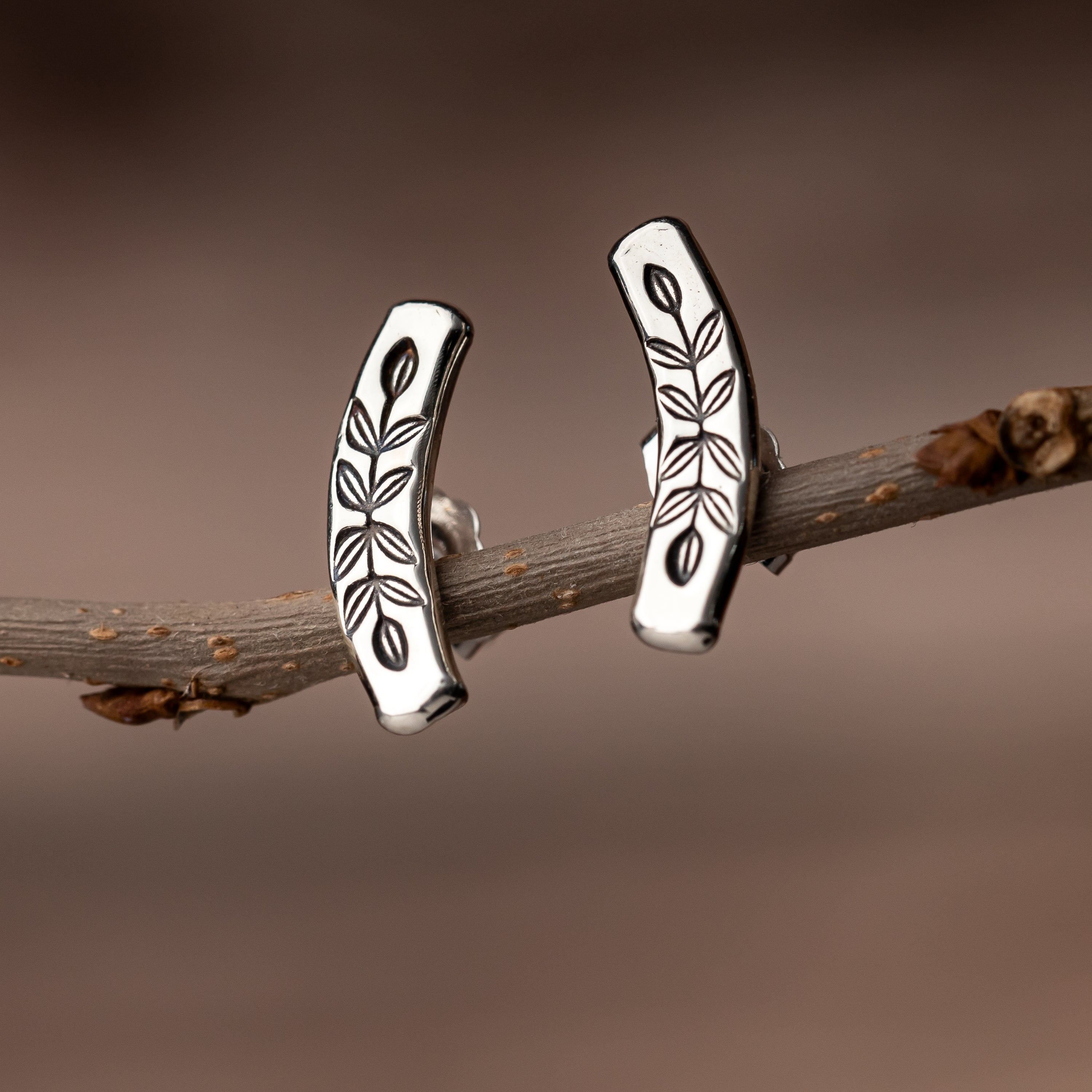 handmade sterling silver stud earrings are hand stamped with a vine motif