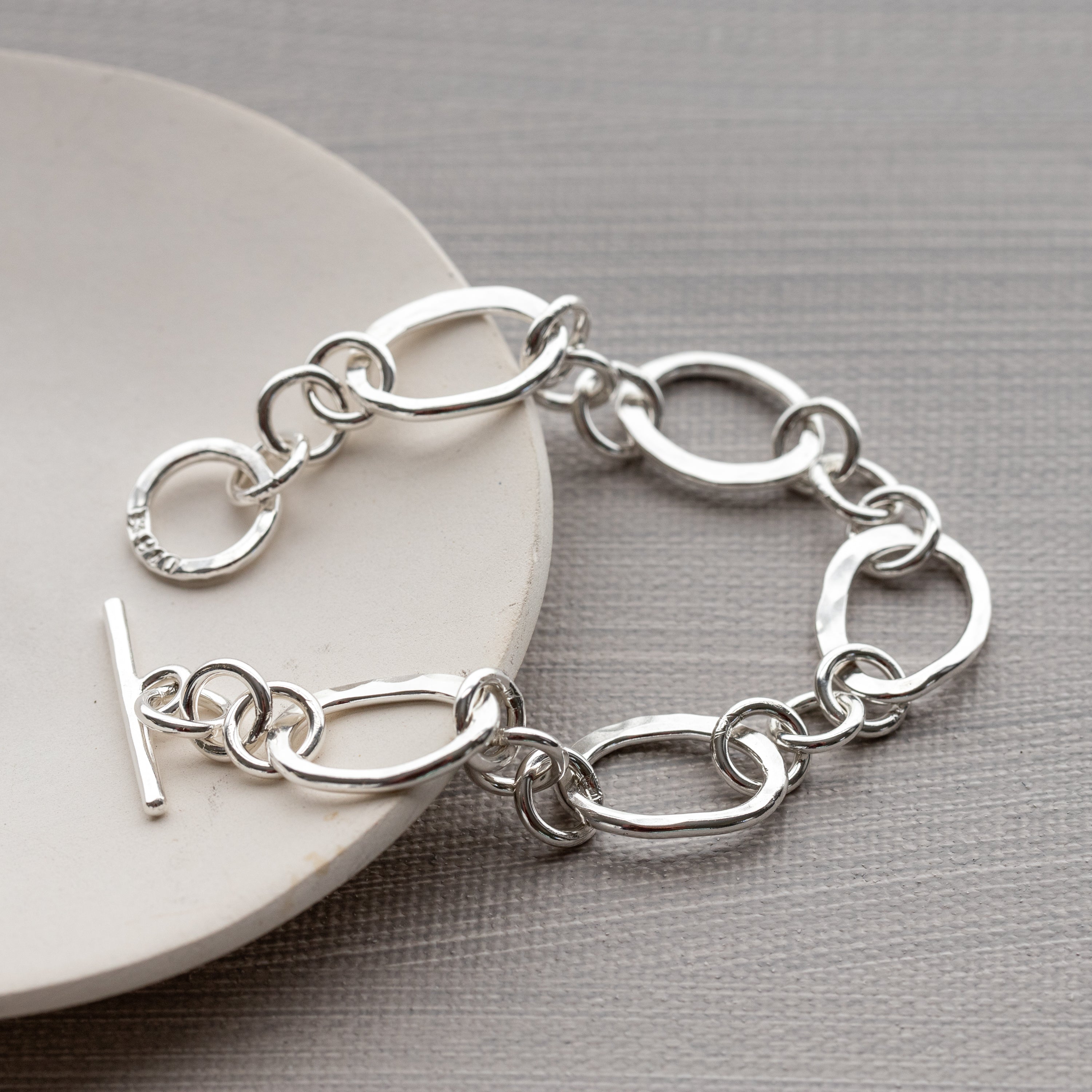 This heavy sterling silver bracelet was handmade with solid Argentium Silver.  It features large hand hammered links and a secure toggle clasp.  Polished to a high shine to reflect the light beautifully from every angle.